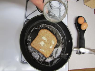 Lay the buttered bread in the pan