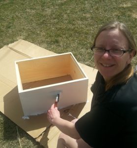 Chaya painting the bee boxes